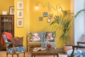 a living room with a couch and a plant at Hôtel Marsiho by HappyCulture - ex Best Western Marseille in Marseille