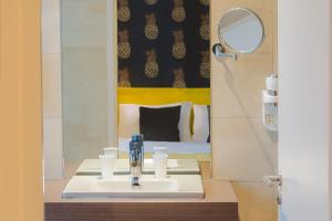 a bathroom with a sink and a mirror at Hôtel Marsiho by HappyCulture - ex Best Western Marseille in Marseille