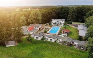 an aerial view of a house with a swimming pool at Forellenhof in Nordhastedt