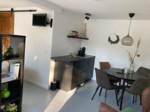a kitchen and dining room with a table and chairs at B&B 't Onderkomen in 't Harde +24 photos