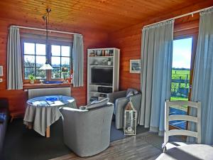 a living room with a table and chairs at Kastanienhof in Kalleby