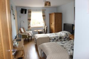 Postel nebo postele na pokoji v ubytování Kilcatten Lodge