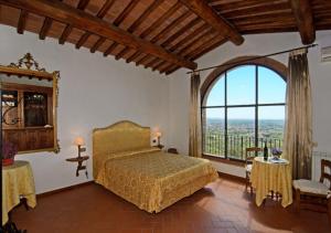 ein Schlafzimmer mit einem Bett und einem großen Fenster in der Unterkunft I Sette Borghi in Massa e Cozzile