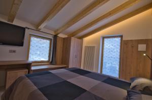 Posteľ alebo postele v izbe v ubytovaní B&B Paganella Relax and Gourmet