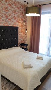 a bedroom with a large bed with towels on it at Active Residence C 408 in Lublin