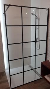a glass shower stall with a shower head at Active Residence C 408 in Lublin