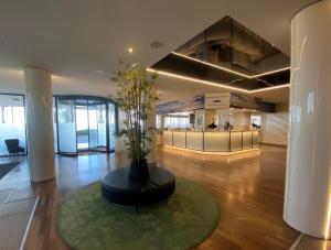 a lobby with a table with a plant in it at Barion Hotel & Congressi in Bari