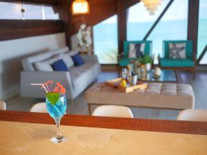a glass sitting on a table in a living room at Pousada Ecos Beach in Porto De Galinhas
