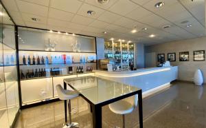 a restaurant with a glass table and two chairs at Barion Hotel & Congressi in Bari