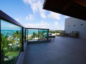 a balcony with a view of the ocean at Pousada Ecos Beach in Porto De Galinhas