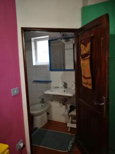 a small bathroom with a sink and a toilet at ALLOGGIO S.ANNA in Isola del Giglio +27 photos
