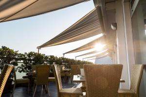 a row of tables and chairs on a patio at Barion Hotel & Congressi in Bari