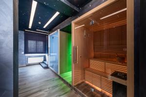 a sauna with green lighting in a room at Barion Hotel & Congressi in Bari