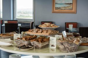 a table filled with different types of pastries at Barion Hotel & Congressi in Bari
