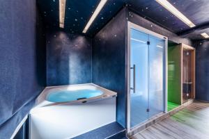 a bathroom with a tub and a glass shower at Barion Hotel & Congressi in Bari