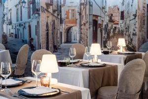 a restaurant with tables and chairs on a street at Barion Hotel & Congressi in Bari