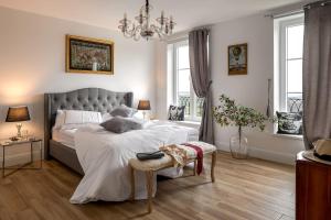 a bedroom with a large bed and a chandelier at Peterc Vineyard Estate in Kojsko