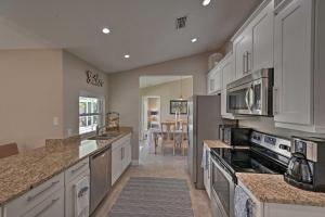 a large kitchen with white cabinets and appliances at Sunny Marco Island Oasis Less Than 2 Miles to Beach! in Marco Island