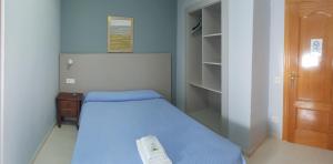A bed or beds in a room at Hostal Soto