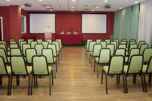a conference room with chairs and a podium in it at Barion Hotel & Congressi in Bari