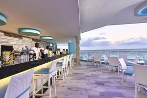 
a restaurant with several tables and chairs at Riu Palace Paradise Island - Adults Only - All Inclusive in Nassau
