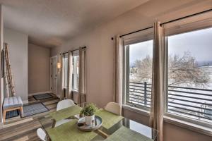 a living room with a table and a large window at Buena Vista Condo, Less Than half Mile to River and Main St! in Buena Vista