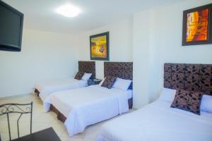 Voodi või voodid majutusasutuse Hotel Presidente Beach Salinas toas