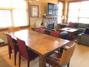 a living room with a wooden table and chairs at Ski in Ski out Minutes from Village, Private Hot Tub Sleeps 6 Free Shuttle in Whistler