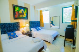 מיטה או מיטות בחדר ב-Hotel Presidente Beach Salinas