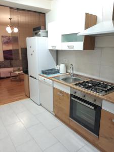 a kitchen with a white refrigerator and a stove top oven at Apartment Mia in Rovinj