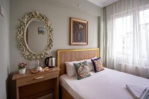um quarto com uma cama com um espelho na parede em Sofia Corner Hotel em Istambul