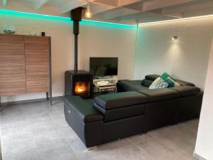 a living room with a couch and a wood stove at Nieuwendamme 130 vakantiewoning voor 6 personen in Nieuwpoort