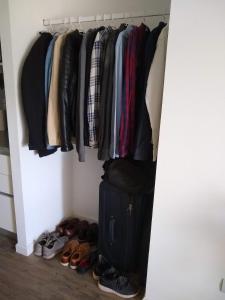 a closet with a bunch of clothes and shoes at Mirador 703 Palermo in Buenos Aires
