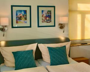 a hotel room with a bed and two pillows at Pension Kurhausblick in Bad Suderode