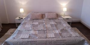 a bedroom with a bed with two tables and two lamps at Center Diamond in Târgu-Mureş
