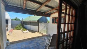 a view of a patio from a window of a house at Faodail Guest House in Velddrif