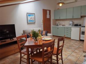 a kitchen and dining room with a table and chairs at Apartments Bevk in Piran