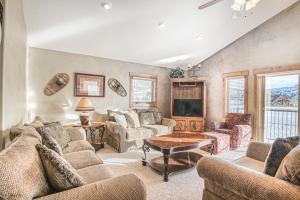 a living room with couches and a tv at Rio Grand Golf Course Home in South Fork