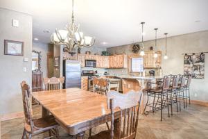 a dining room and kitchen with a wooden table and chairs at Rio Grand Golf Course Home in South Fork