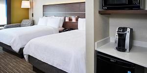 a hotel room with two beds and a television at Holiday Inn Express - Canton by IHG in Canton