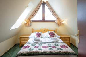 a bedroom with a bed with a large window at Willa Monte Rosa in Zakopane