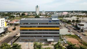 a building with a yellow stripe on it in a city at Transamerica FIT Sinop in Sinop