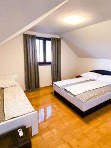 1 dormitorio con 2 camas en un ático en Villa Una Residence, en Bihać