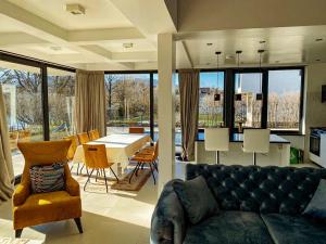 a living room with a couch and a table and chairs at Villa Una Residence in Bihać