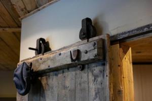 an open wooden door with handles on a wall at LOFT nelle Valli in Pessinetto
