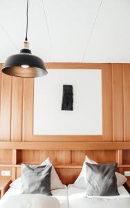 a bedroom with a bed and a pendant light at die MÜHLE #10 in Reichenfels