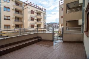a balcony with a view of two buildings at Apartman EROS in Vrnjačka Banja