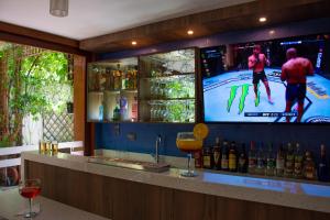a bar with a television and bottles of wine at Refugio Ecológico Arequipa in Arequipa