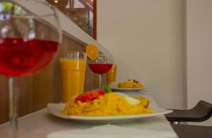 a table with two plates of food and a glass of wine at Refugio Ecológico Arequipa in Arequipa
