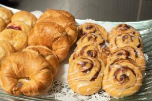 a bunch of croissants and other pastries on a tray at Holiday Inn Louisville East - Hurstbourne, an IHG Hotel in Louisville